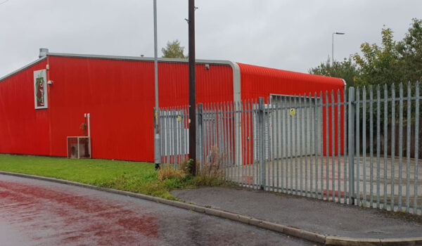 red cladding 1970s delipidated red painted unit