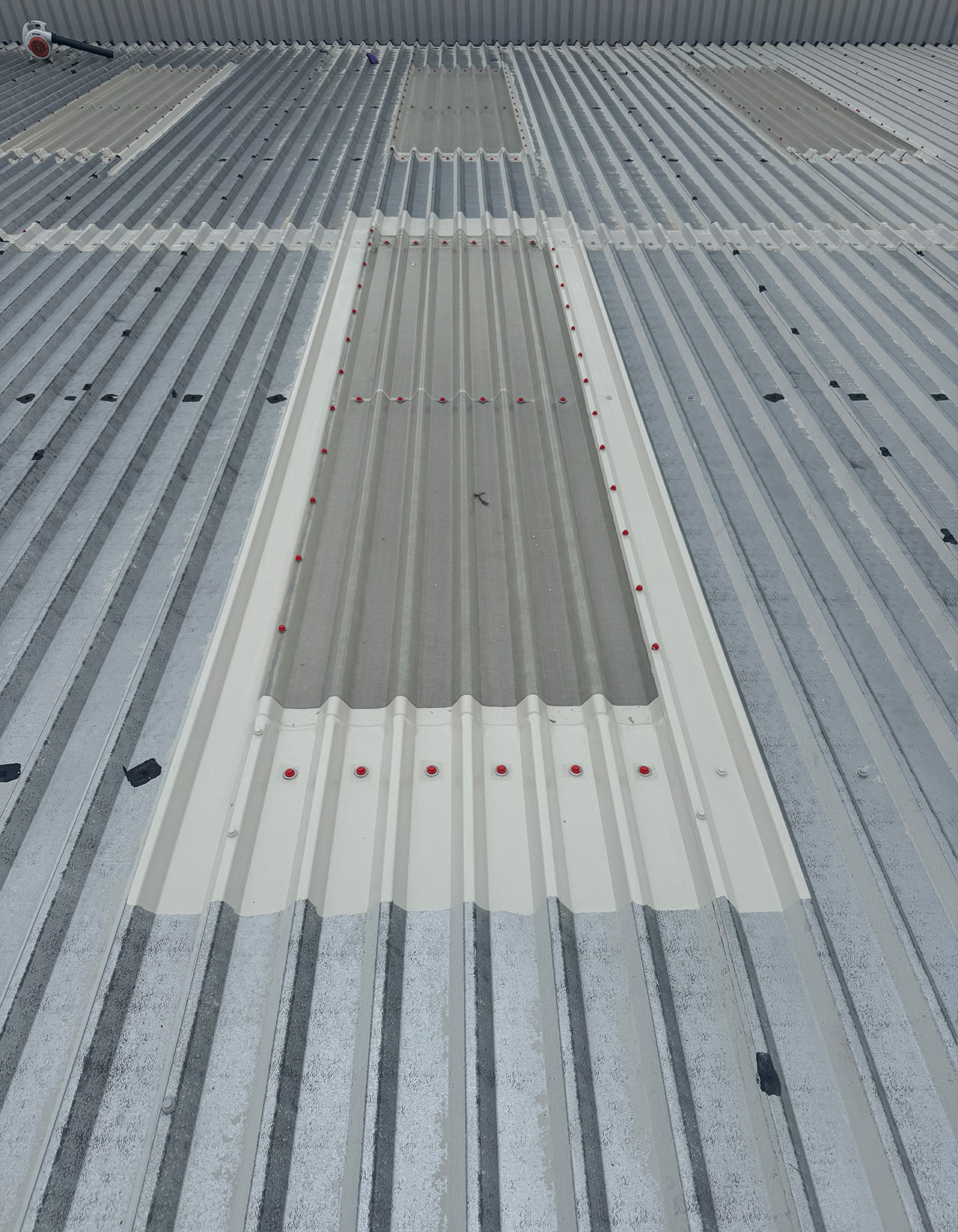 Cut edge and rooflight edge corrosion treatment large retail unit roof