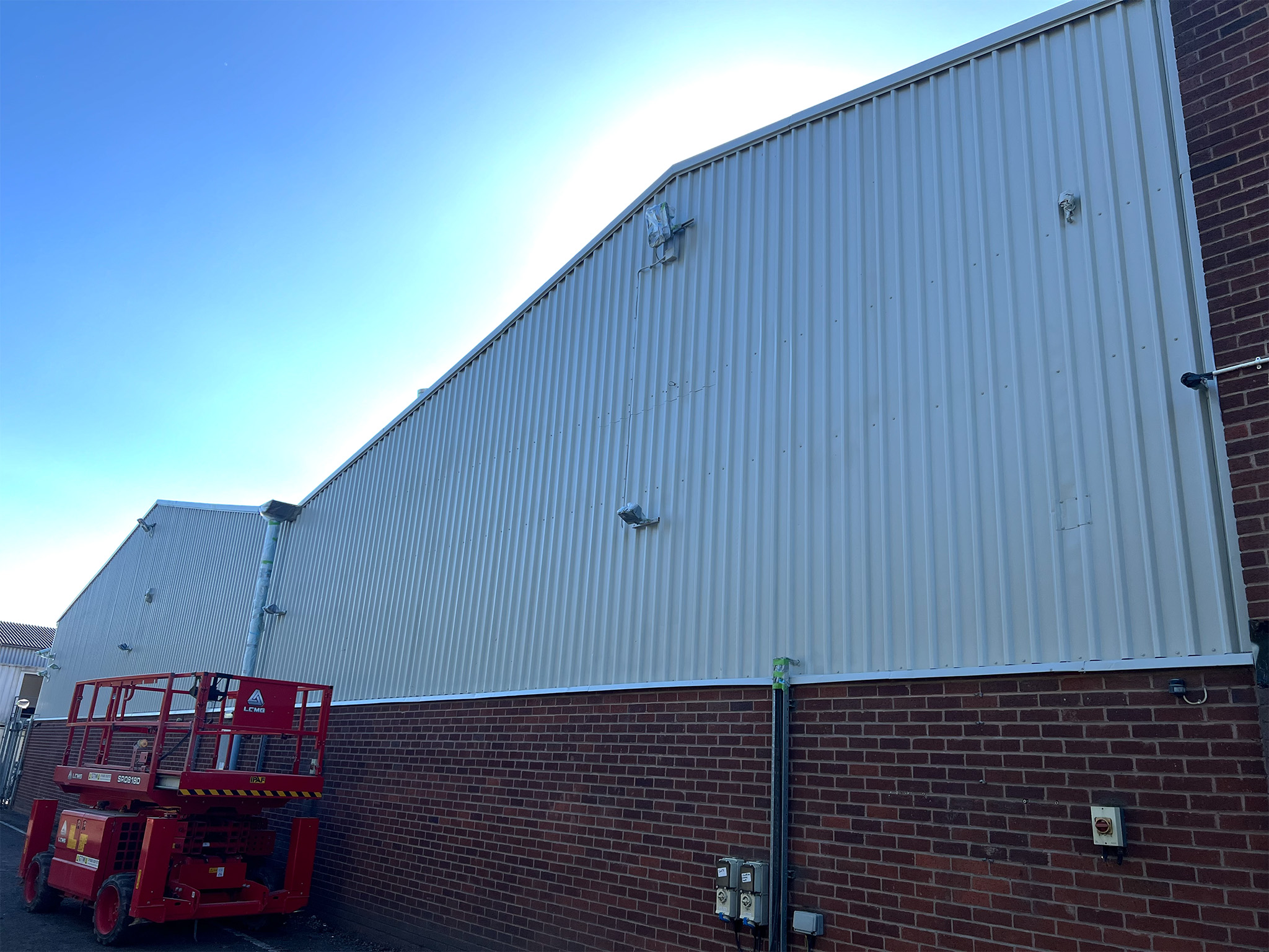 Steel cladding work complete at gable ends of industrial unit