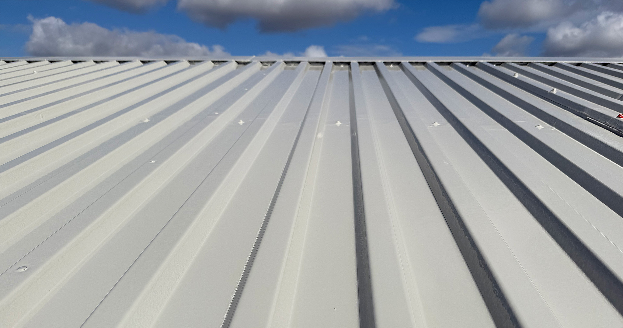 Close up of a completed DriSilane ReCote roof coating on corrugated steel sheeting