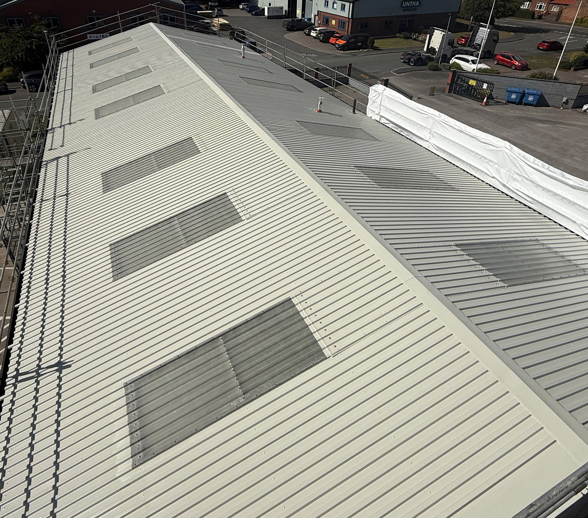 Aerial view of a large commercial roof following completion of a full roof coating