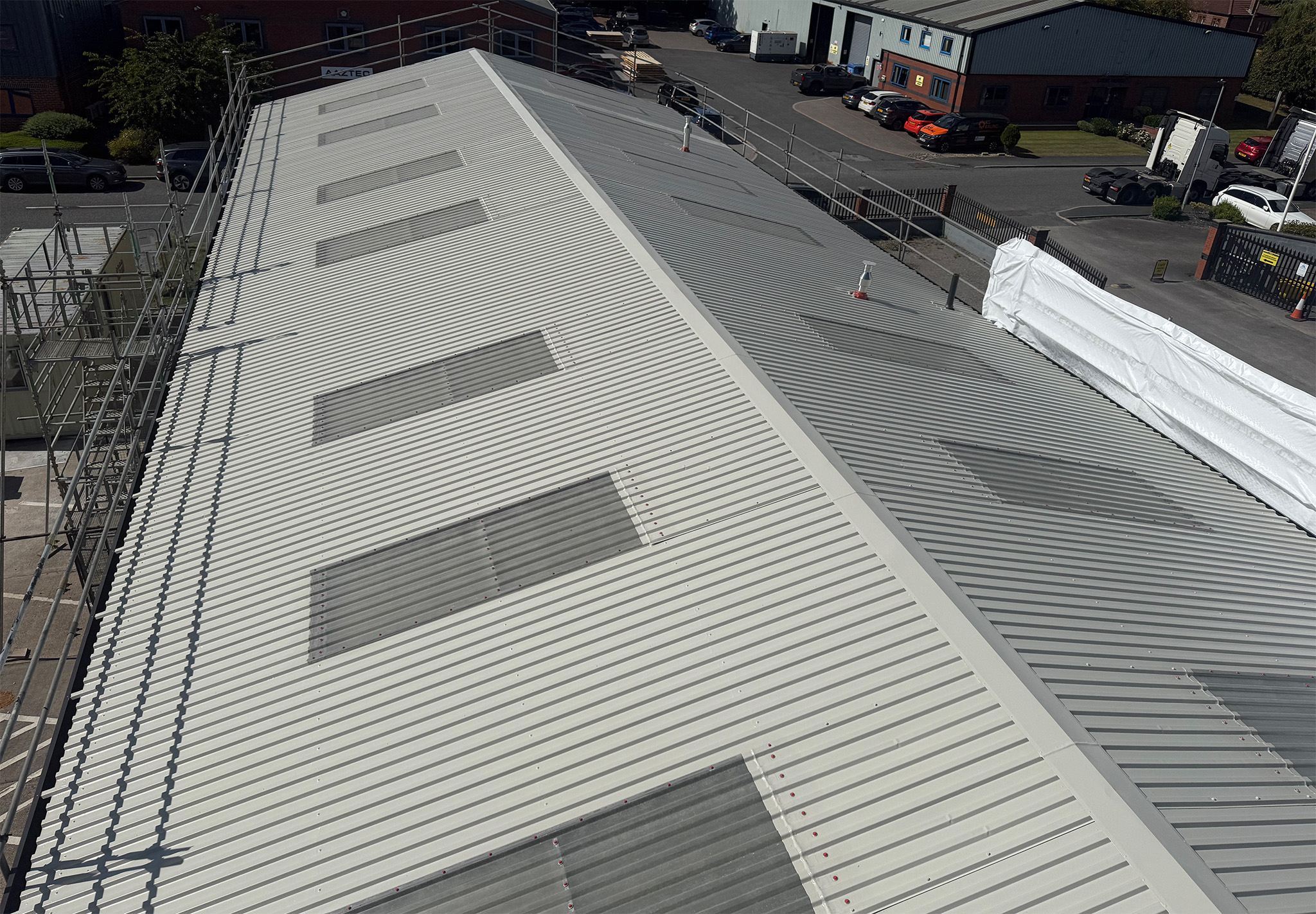 Completed commercial roof coating viewed from the scaffold access tower