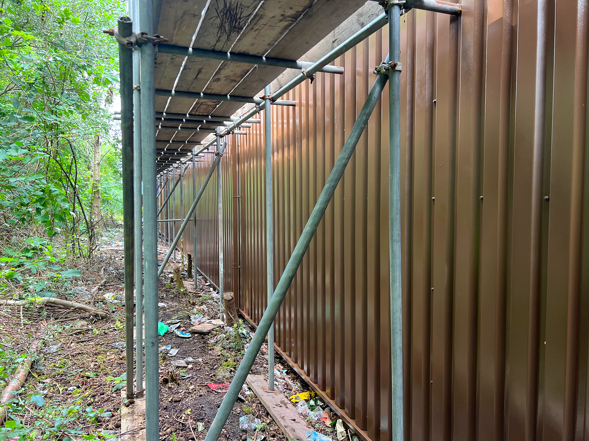 Completed cladding coating to rear elevation accessed via scaffolding where boom lift access was limited