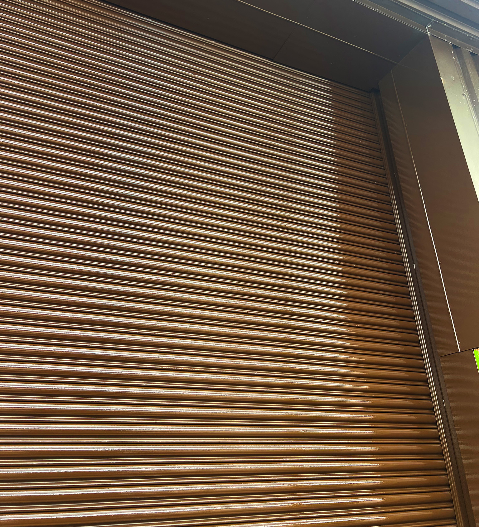 Steel roller shutters recoated in Tikkurila Temadur 20 chestnut brown