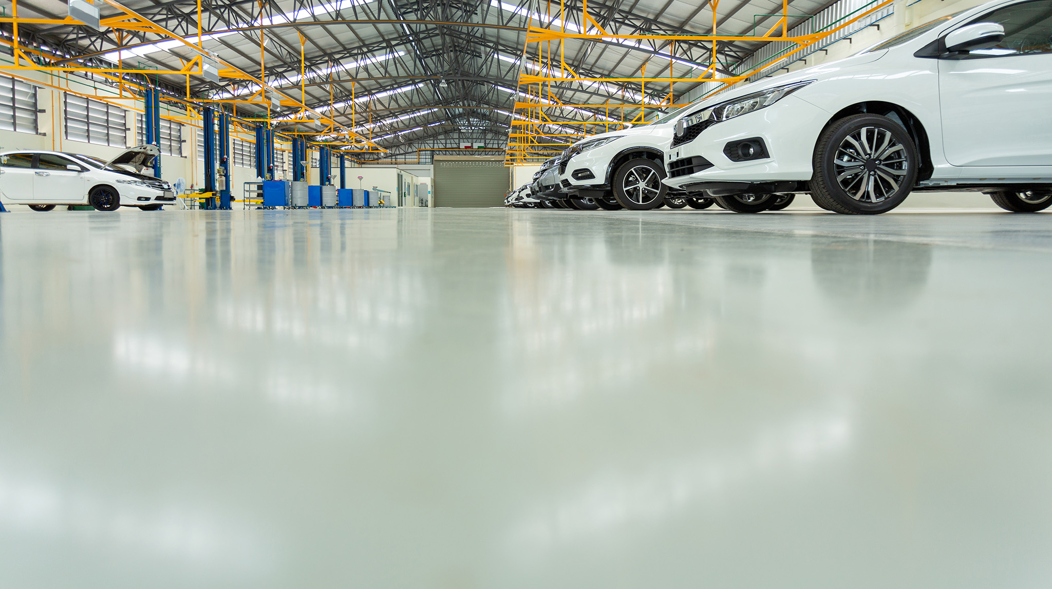 large car service warehouse concrete floor newly painted